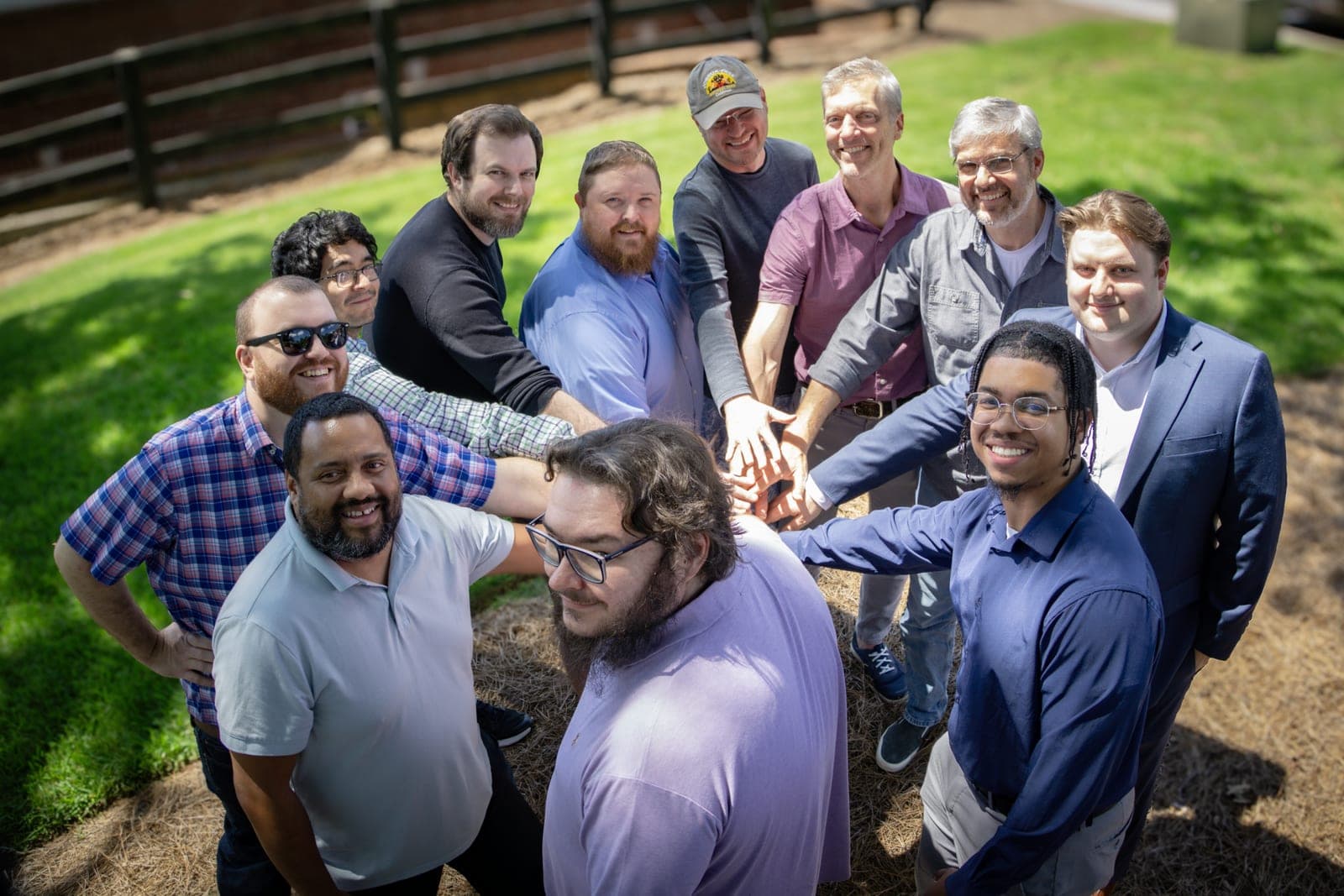 The 360Works team gathered together for a group portrait, framed in a circular composition.